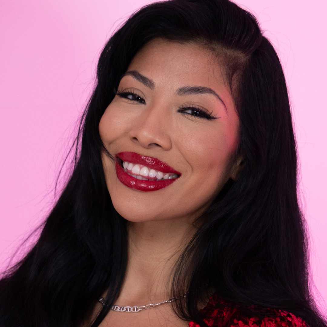 Headshot of Selena Tribute on a pink background